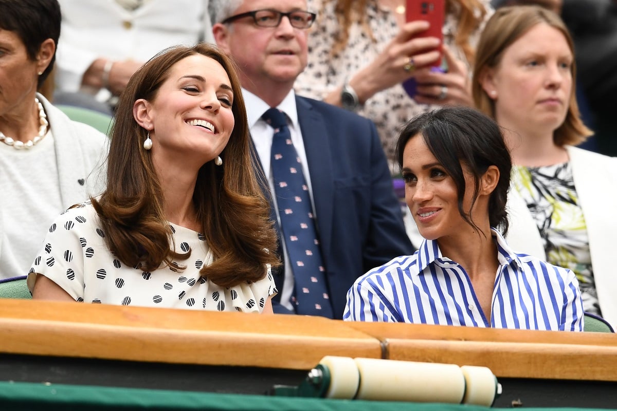 Kate Middleton and Meghan Markle attend the Wimbledon Lawn Tennis Championships at All England Lawn Tennis and Croquet Club