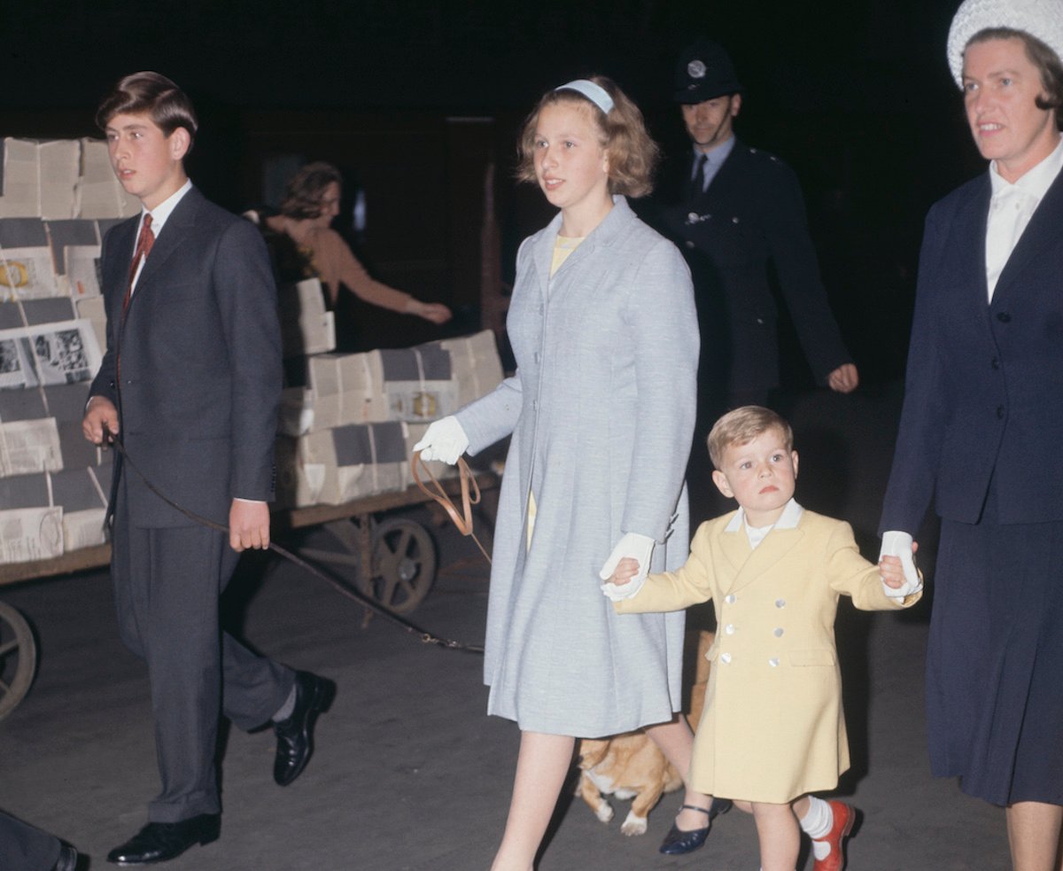 King Charles III, whose childhood photo with Queen Elizabeth II demonstrated 'heartbreaking' relationship according to author, walks with Princess Anne, Prince Andrew, and Mabel Anderson in 1963