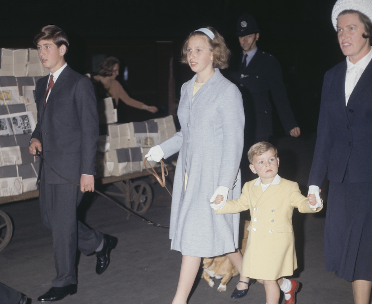 King Charles III, whose childhood photo with Queen Elizabeth II demonstrated 'heartbreaking' relationship according to author, walks with Princess Anne, Prince Andrew, and Mabel Anderson in 1963