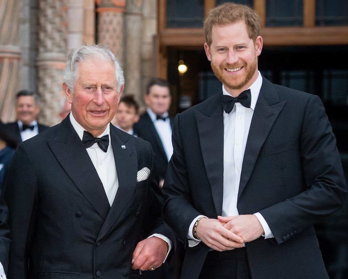 King Charles III and Prince Harry, who can deputize for King Charles as a counsellor of state, smile wearing tuxedos
