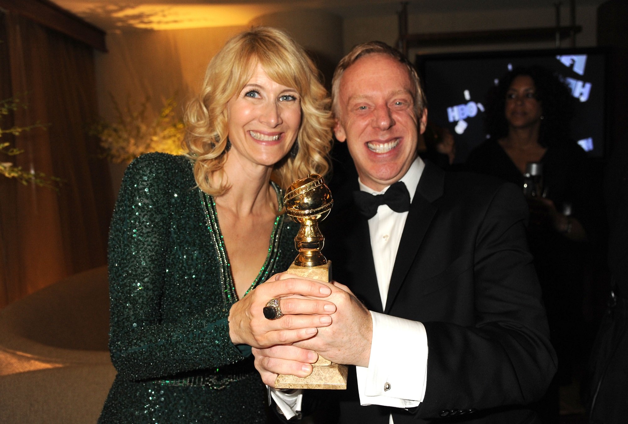 Laura Dern with 'The White Lotus' creator Mike White holding a Golden Globe award trophy