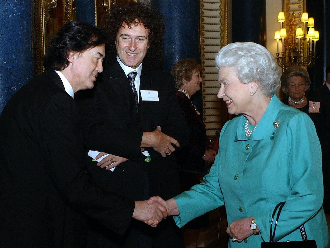Led Zeppelin's Jimmy Page (left) and Queen guitarist Brian May meet Queen Elizabeth II (right) in 2005.