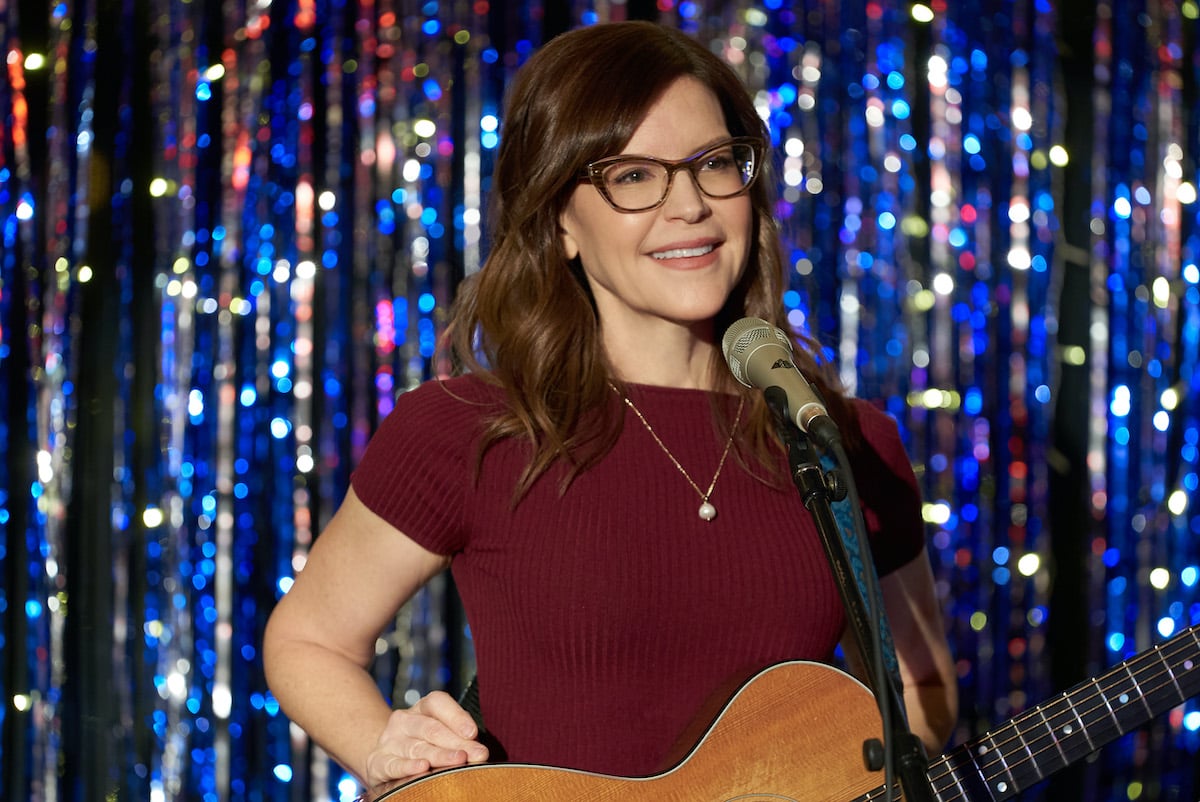 Lisa Loeb holding a guitar in Hallmark Channel's 'Hanukkah on Rye'