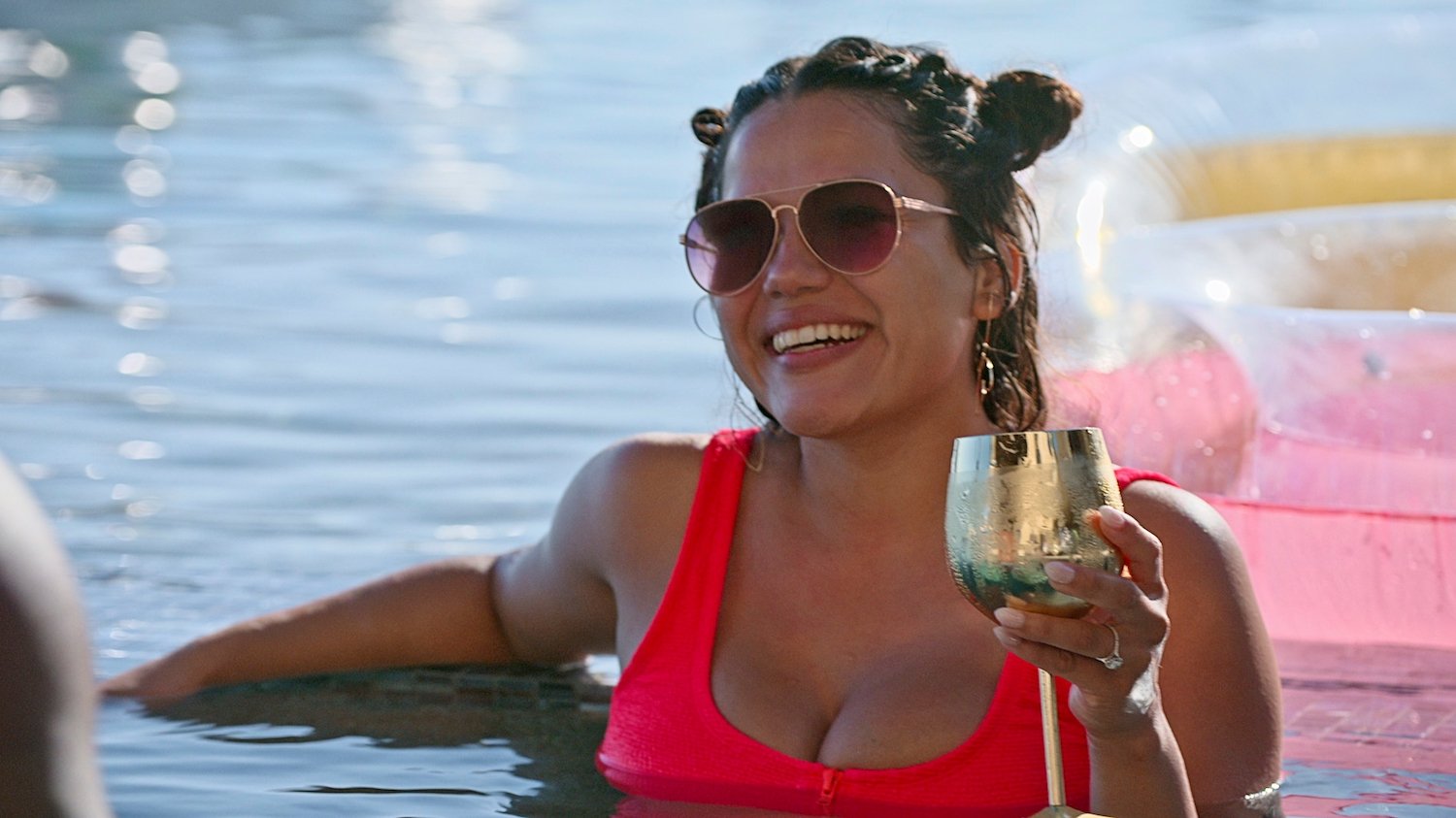 'Love Is Blind' star Nancy holds a cup while swimming in a pool. Nancy rejected Andrew in the pods and he faked tears to seem sad.