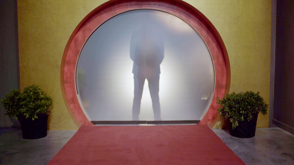 A contestant wearing a suit stands behind a fogged glass partition on "Love Is Blind," which has already filmed season 4.