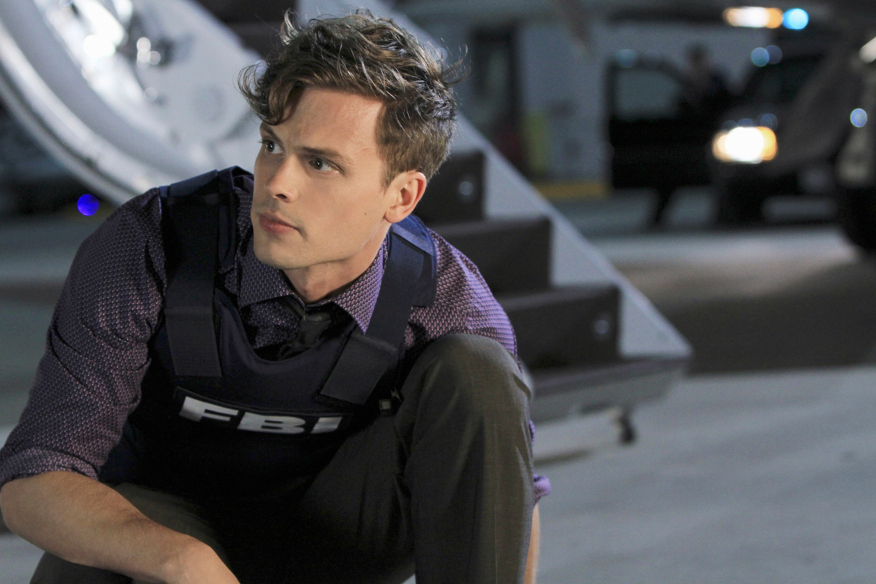 Matthew Gray Gubler, kneeling and wearing a bulletproof vest in 'Criminal Minds'