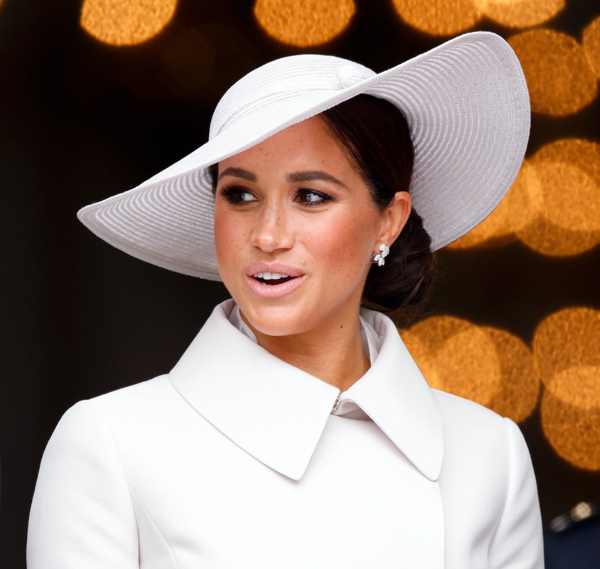 mom to two kids Meghan Markle wears a large asymmetrical white hate