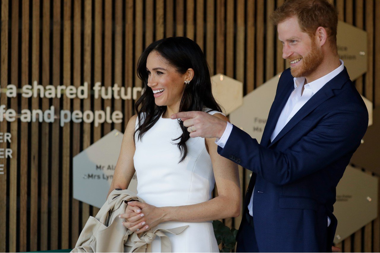 Meghan Markle and Prince Harry stand next to each other.