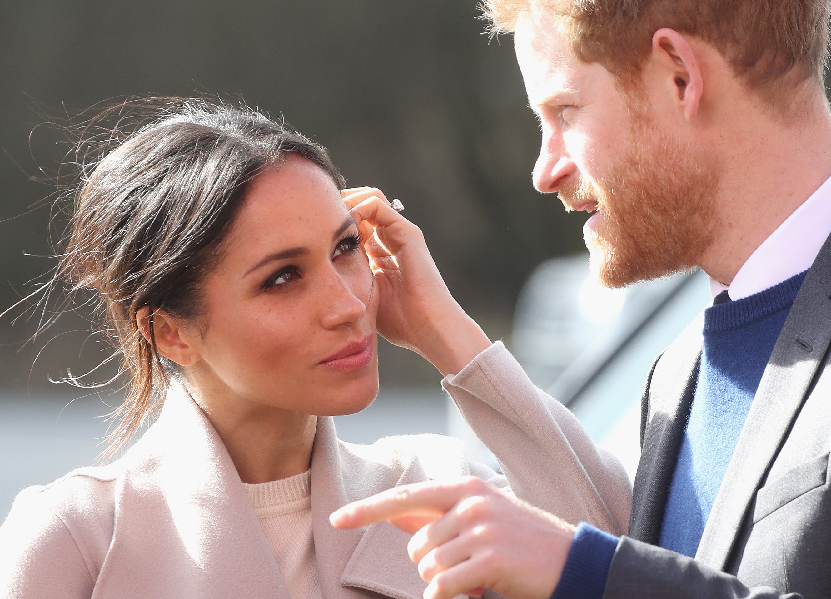 Meghan Markle looks lovingly at Prince Harry.