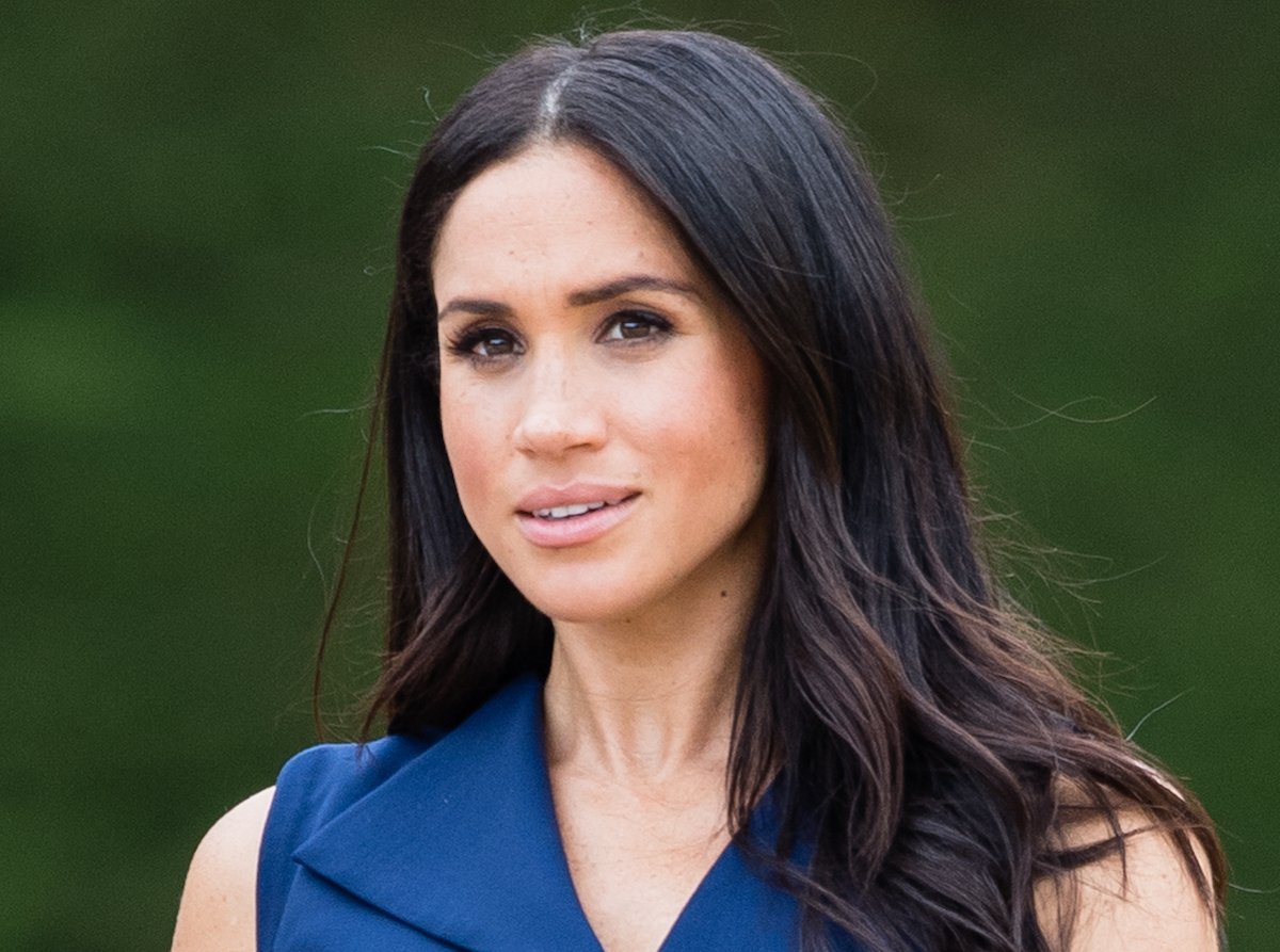 Meghan Markle, whose 'facial expression is special' in a Nov. 8 Archewell photo encouraging people to vote in midterm elections, according to a body language expert, looks on