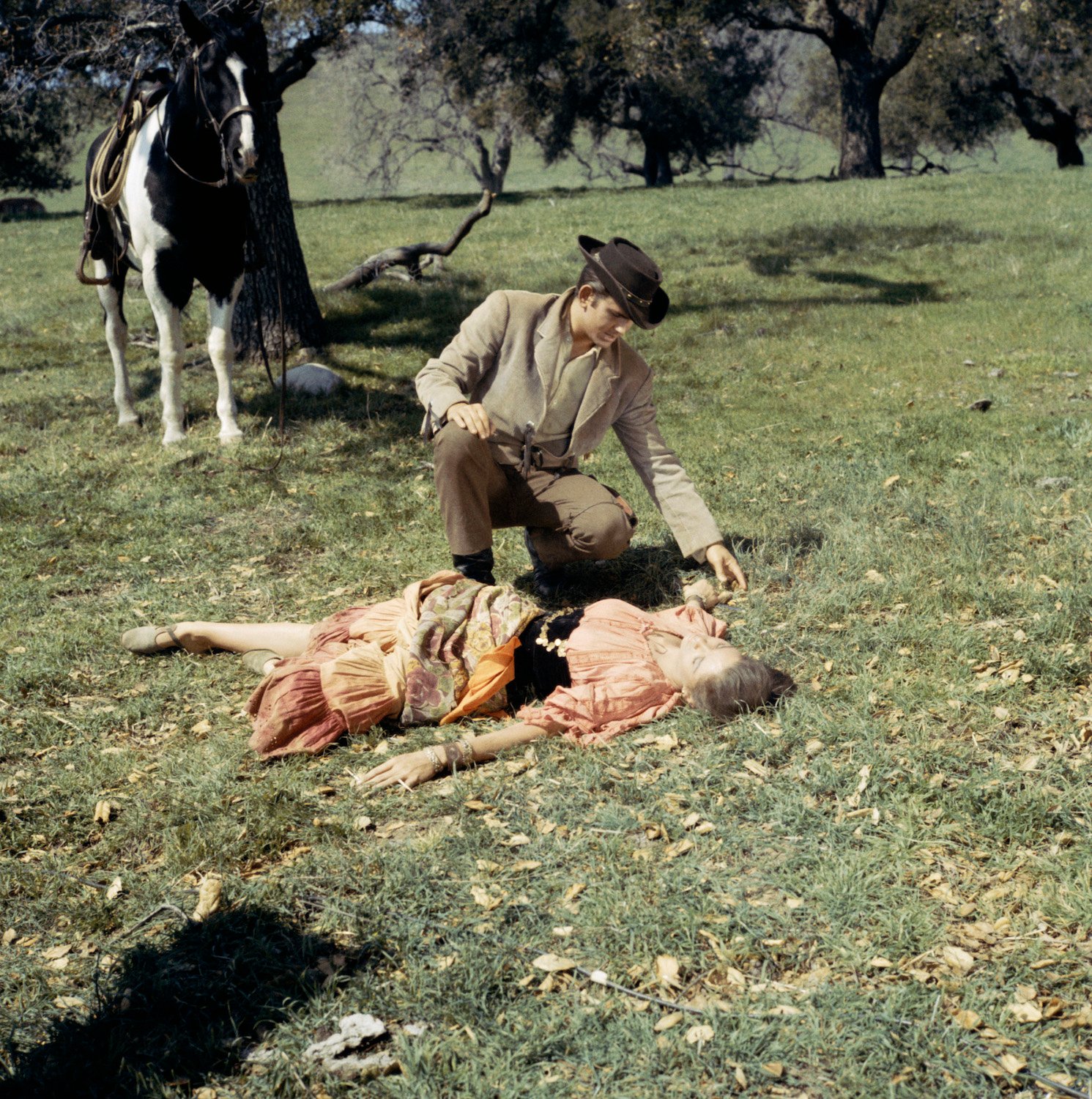 Michael Landon standing over a woman on the ground in 'Bonanza'