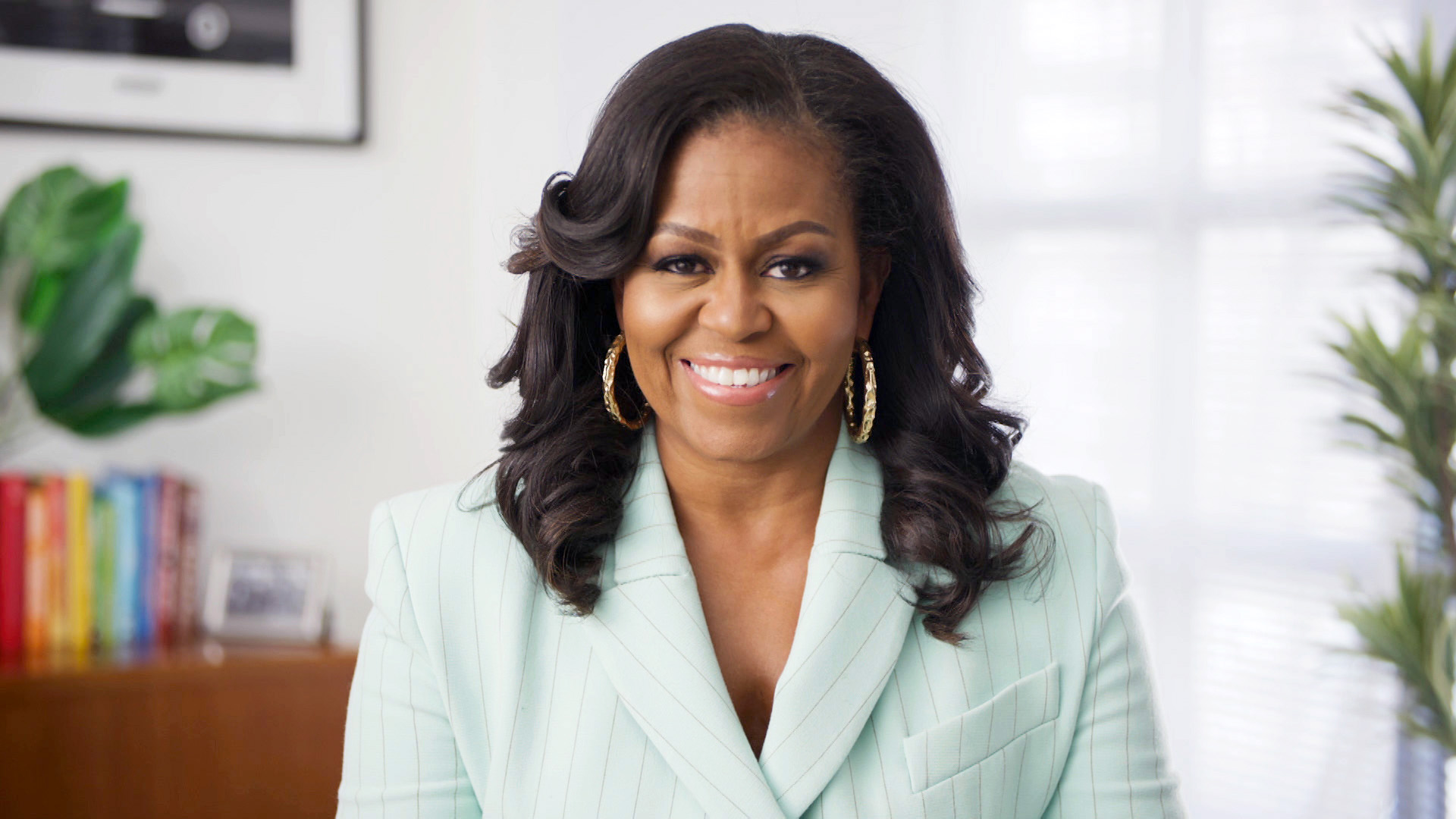 Michelle Obama wearing a seafoam green jacket