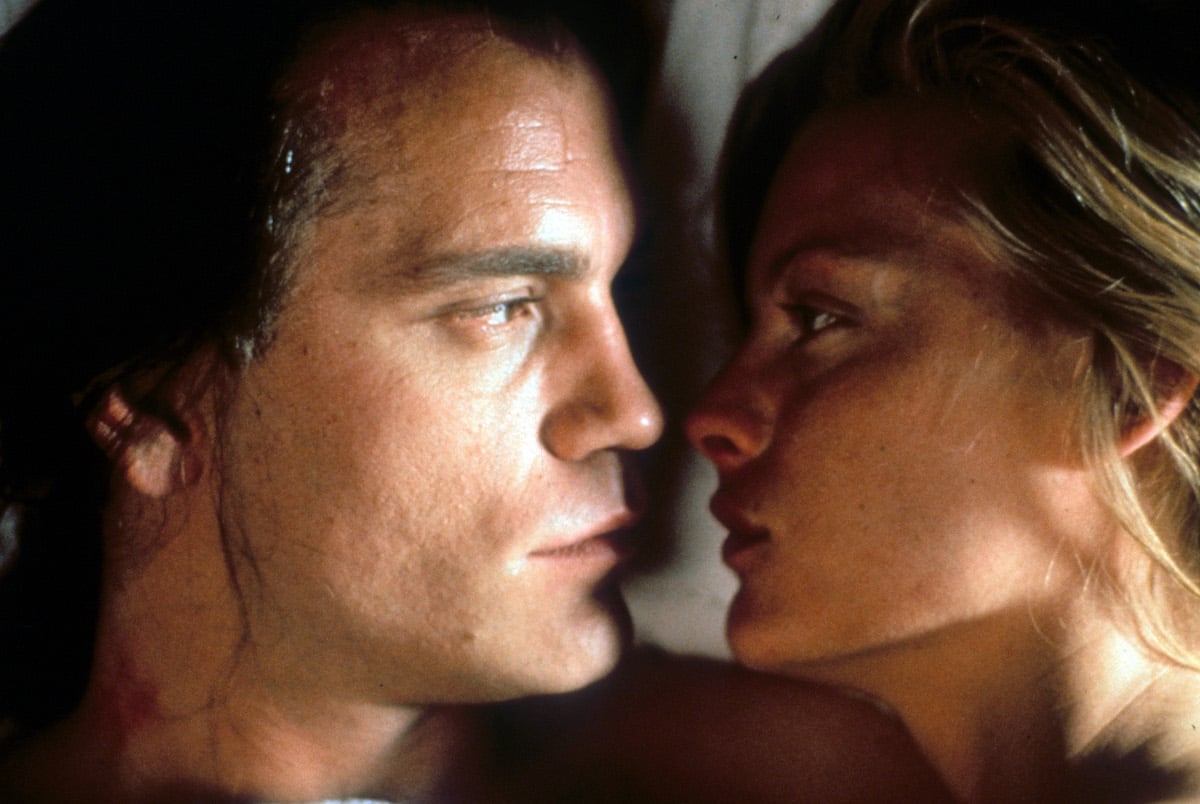 Michelle Pfeiffer and John Malkovich face to face looking intensely into one an others eyes in a scene from the film 'Dangerous Liaisons'