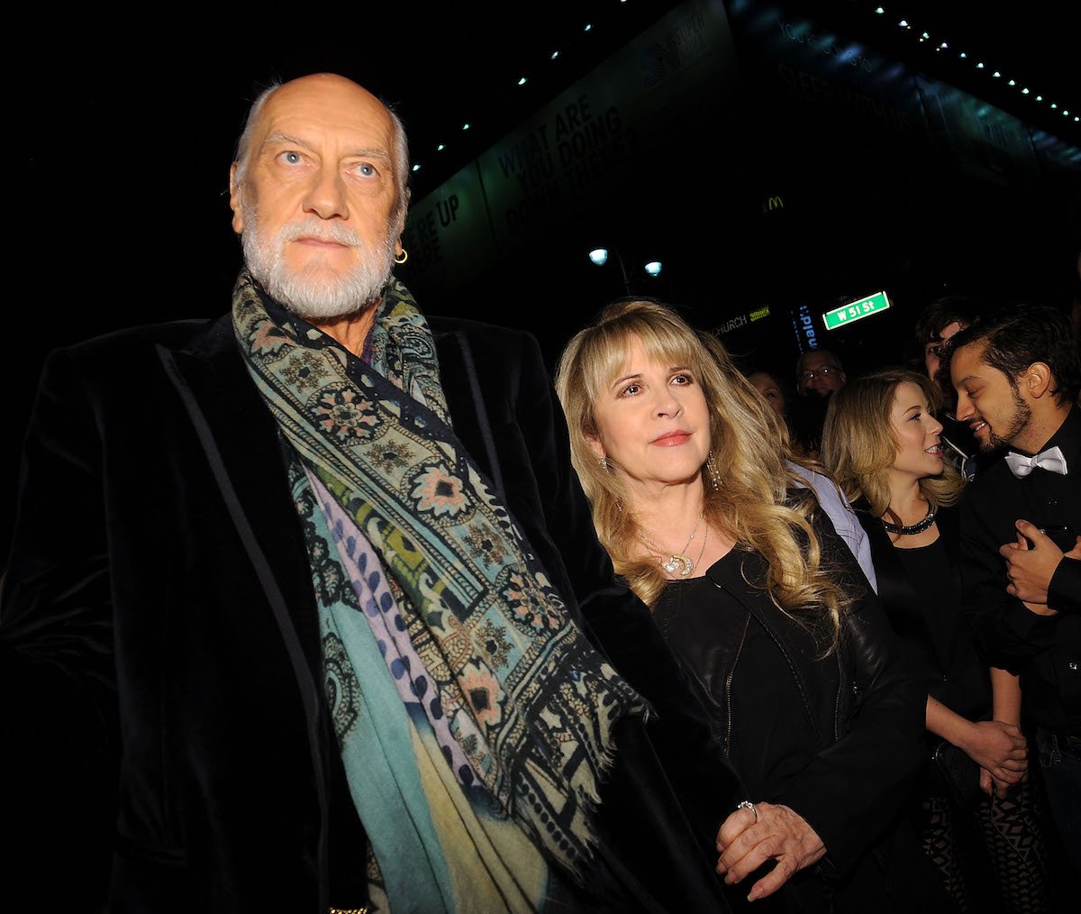 Mick Fleetwood and Stevie Nicks, who had an affair while touring with Fleetwood Mac, walk through a crowd together.