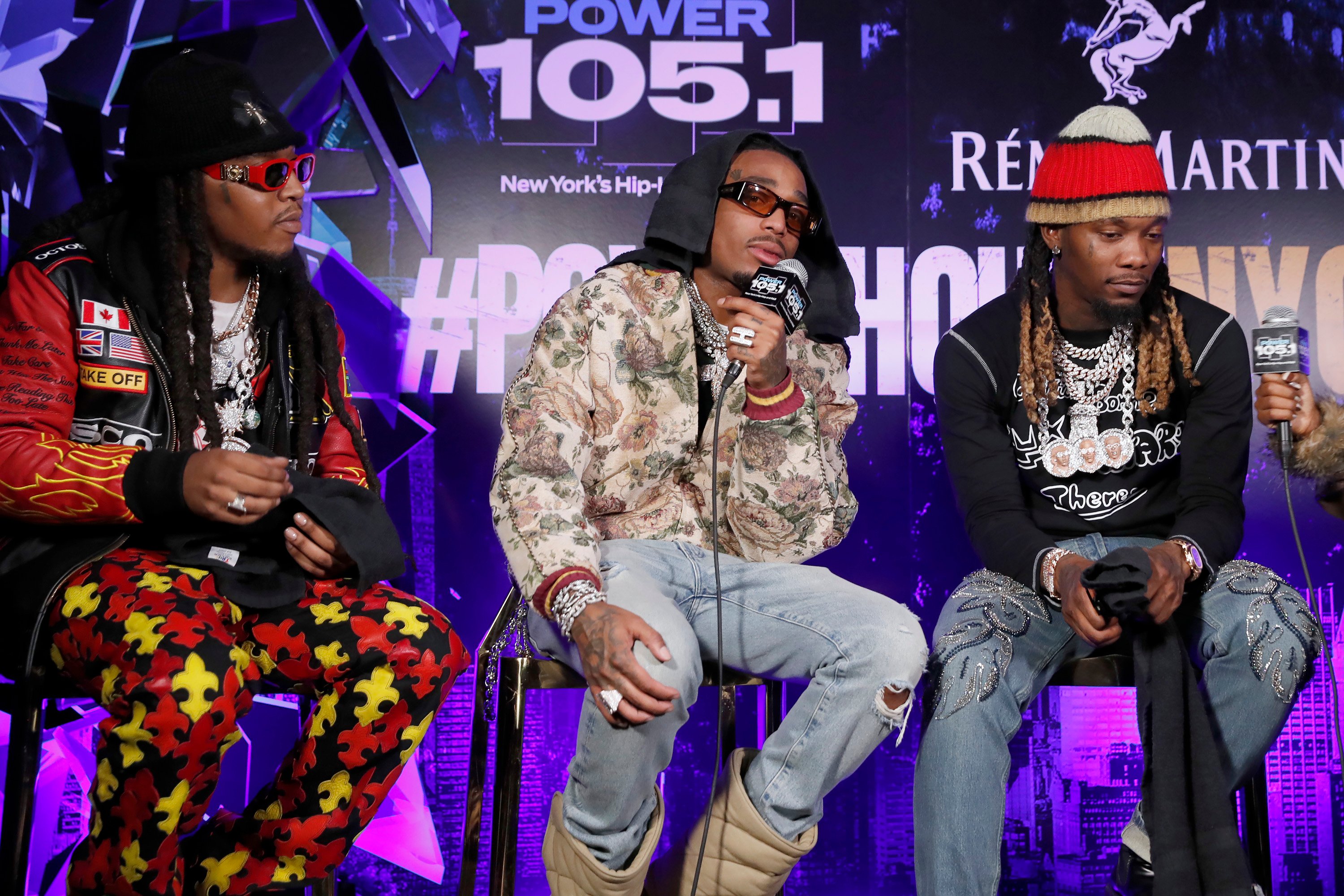 The members of Migos sit on chairs during a radio show appearance
