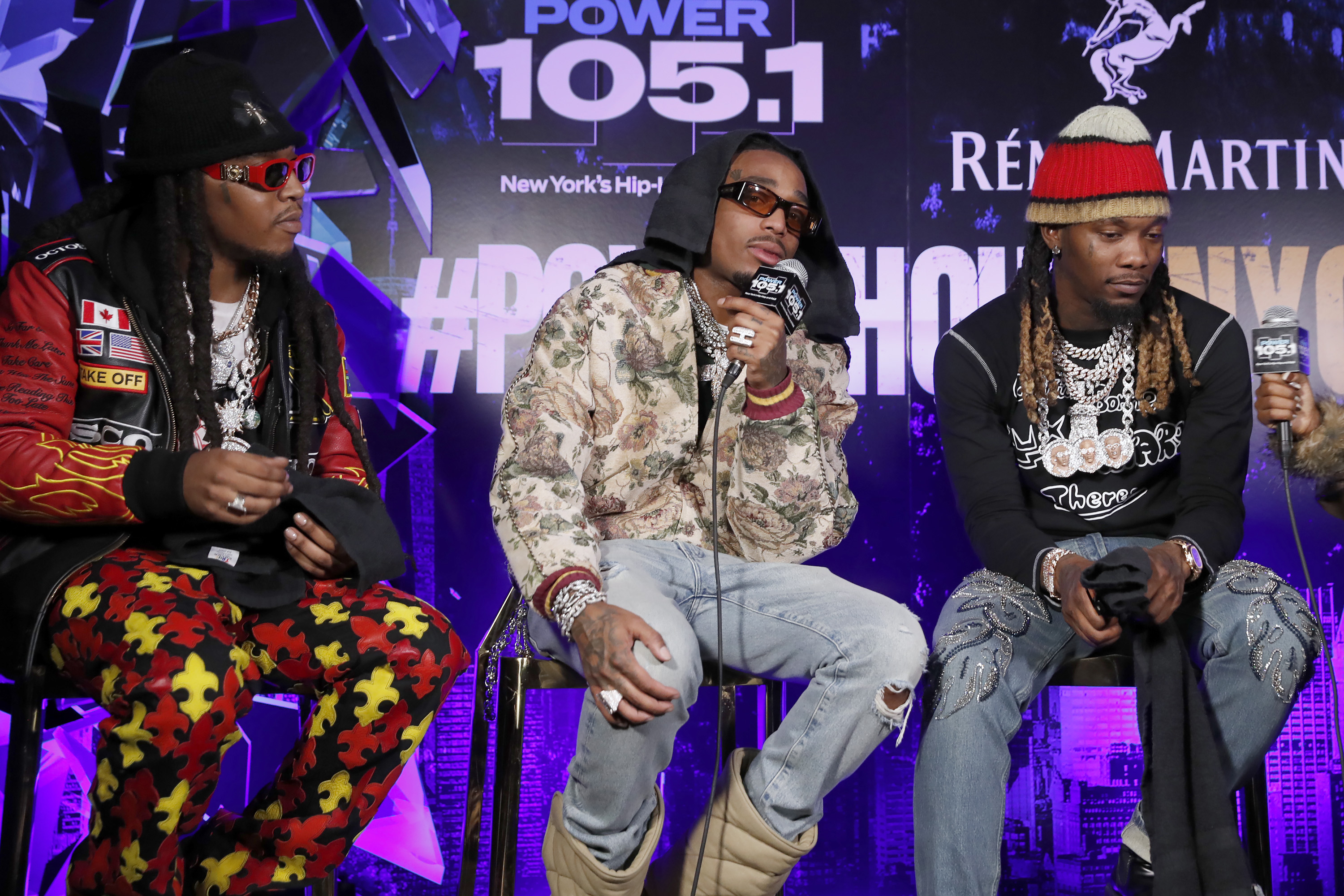 The members of Migos sit on chairs during a radio show appearance