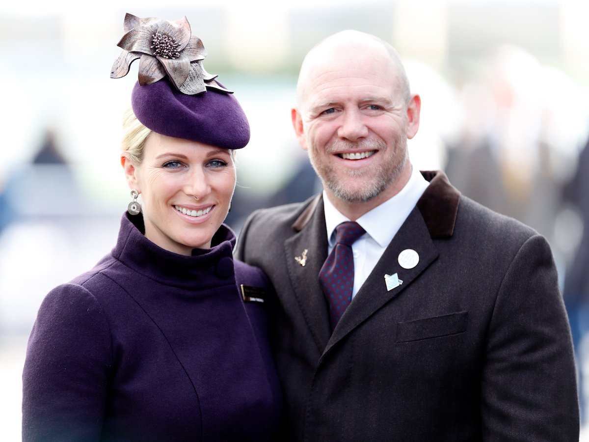Zara Phillips and Mike Tindall smile and pose together at an event.