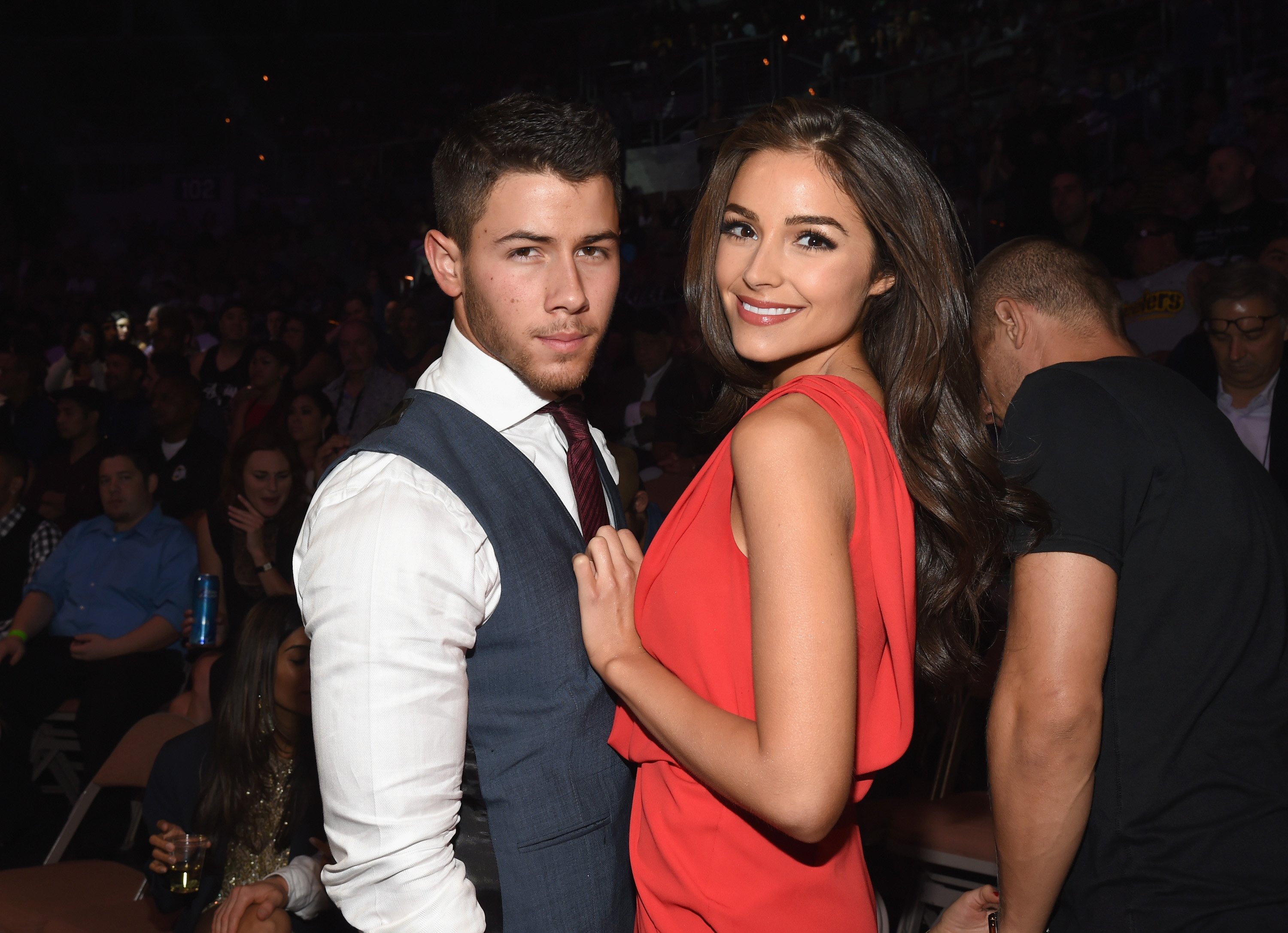 Nick Jonas and Olivia Culpo stand next to each other. 