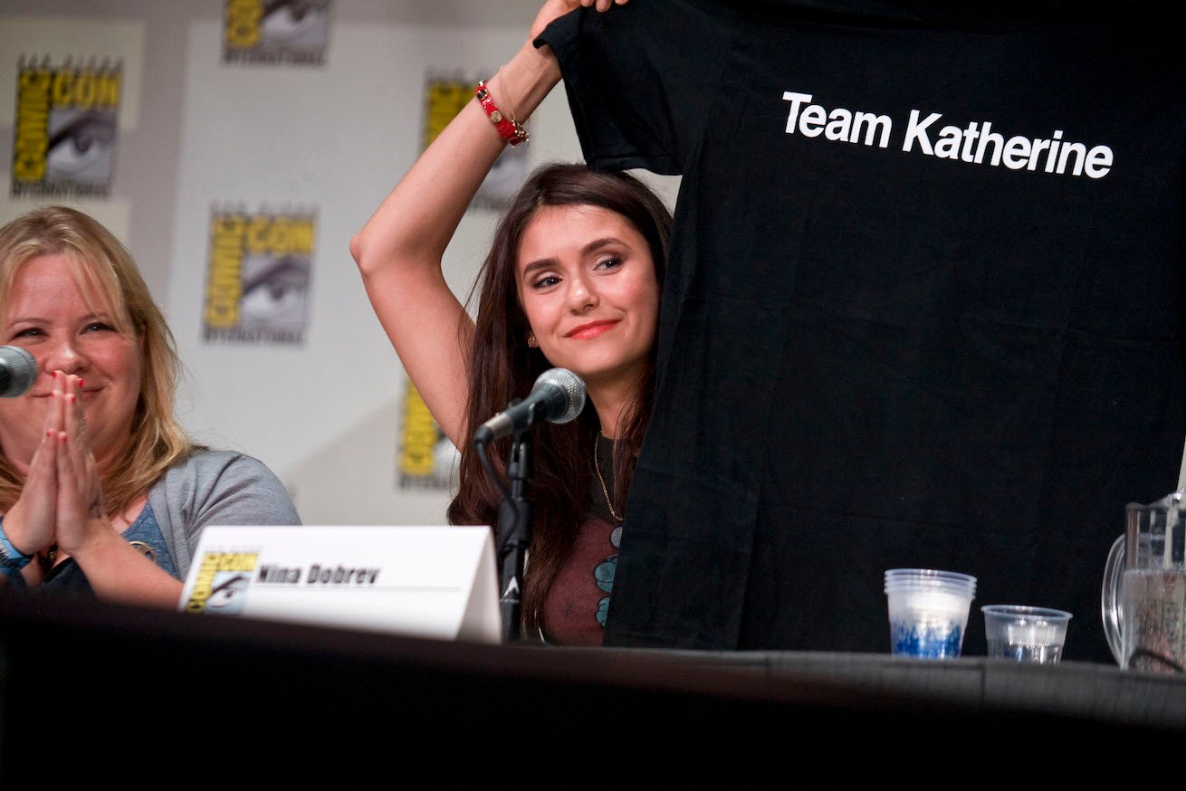 Nina Dobrev at 'The Vampire Diaries' panel holding up a 'Team Katherine' T-shirt