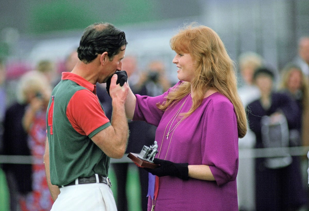 Now-King Charles III, who invited Sarah Ferguson to Christmas at Sandringham, kisses duchess's hand as she presents him with a prize after a polo match