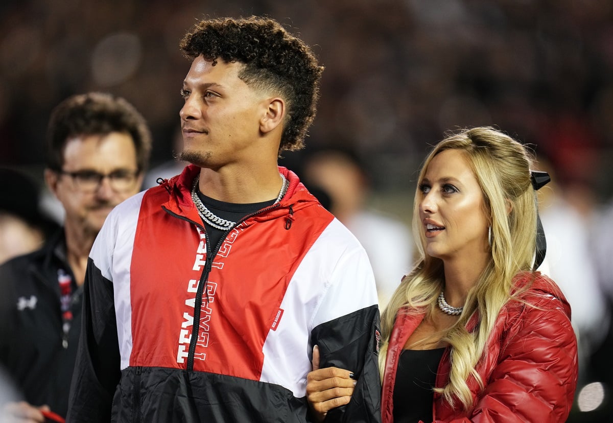 Patrick Mahomes standing with his wife, Brittany, as he's inducted into the Texas Tech Red Raiders Ring of Honor