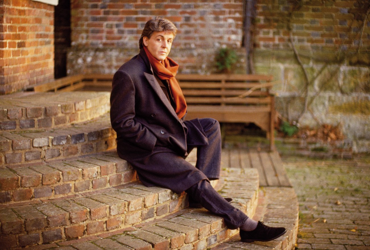 Paul McCartney sitting on steps in 1987.