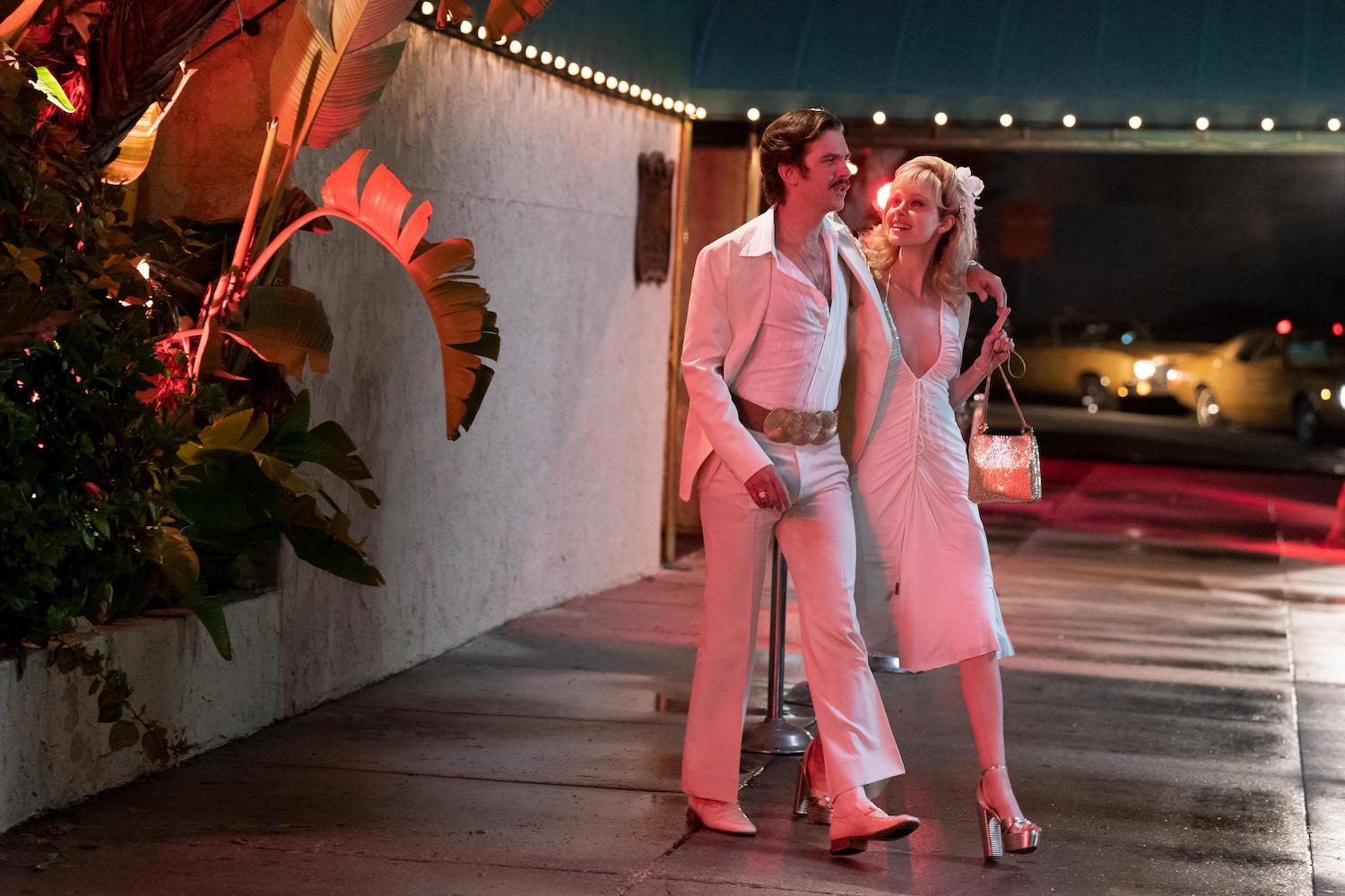 'Welcome to Chippendales' stars Dan Stevens and Nicola Peltz Beckham as Paul Snider and Dorothy Stratten, seen here in a production still walking out of a nightclub while both wear all white.