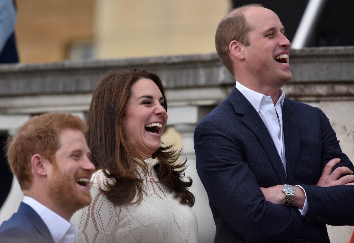 Prince Harry, whose jokes and humor similar to Mike Tindall and other royals can be 'risky' according to a body language expert, laughs with Kate Middleton and Prince William