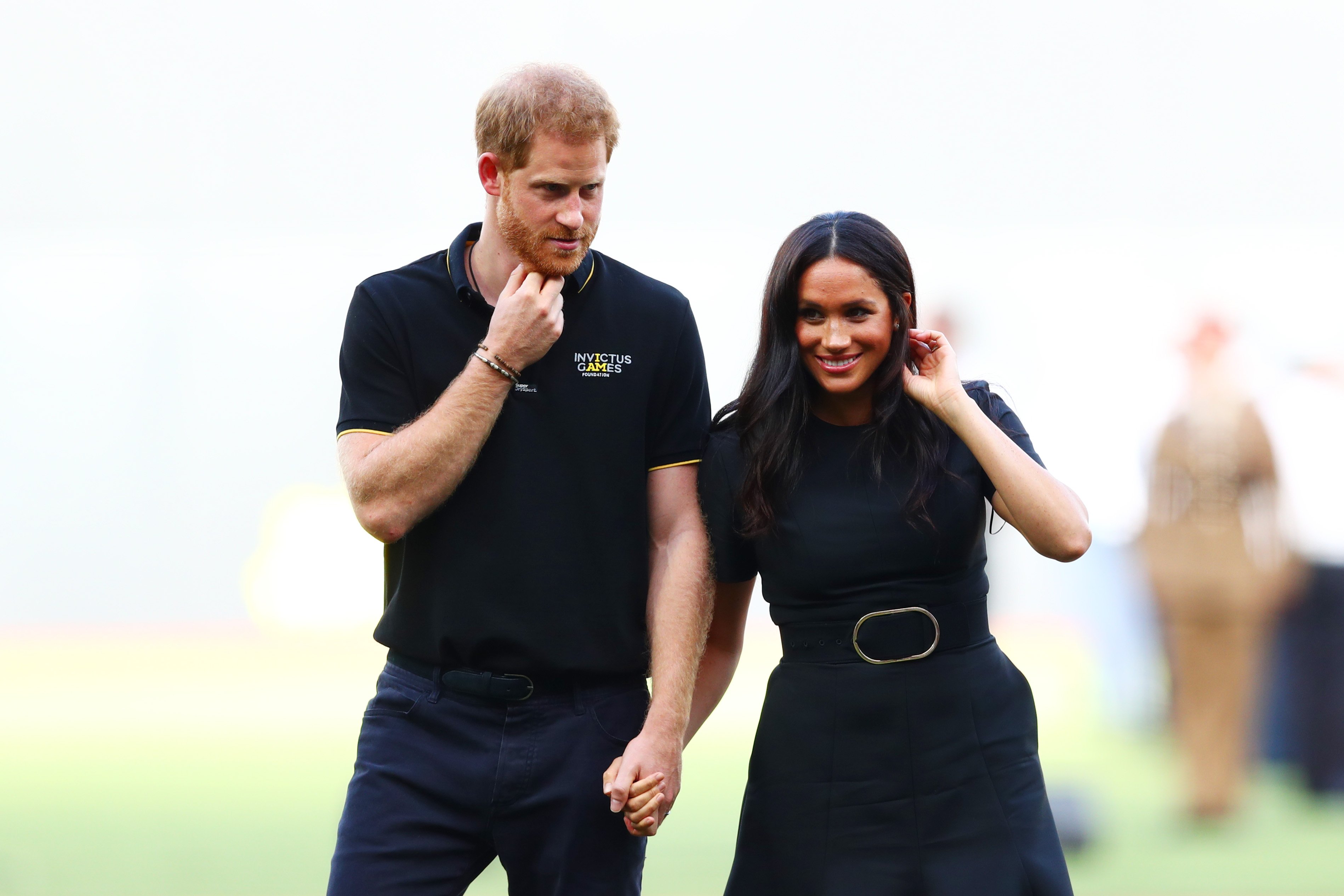 Prince Harry and Meghan Markle hold hands during the Invictus Games.