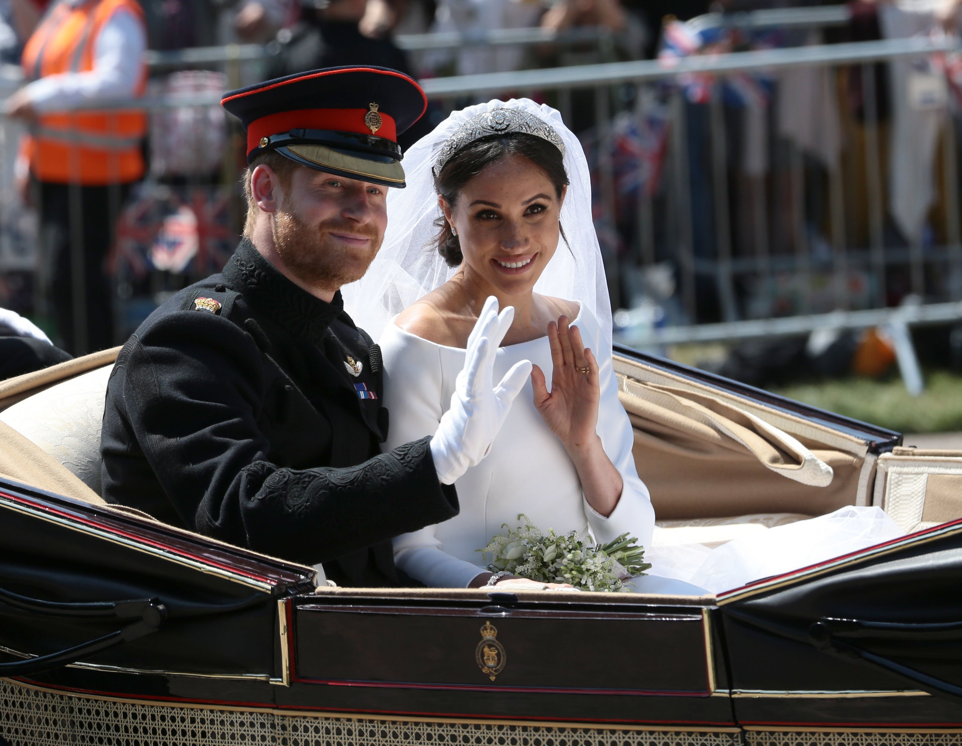 Prince Harry and Meghan Markle wave from the Ascot Landau Carriage after wedding