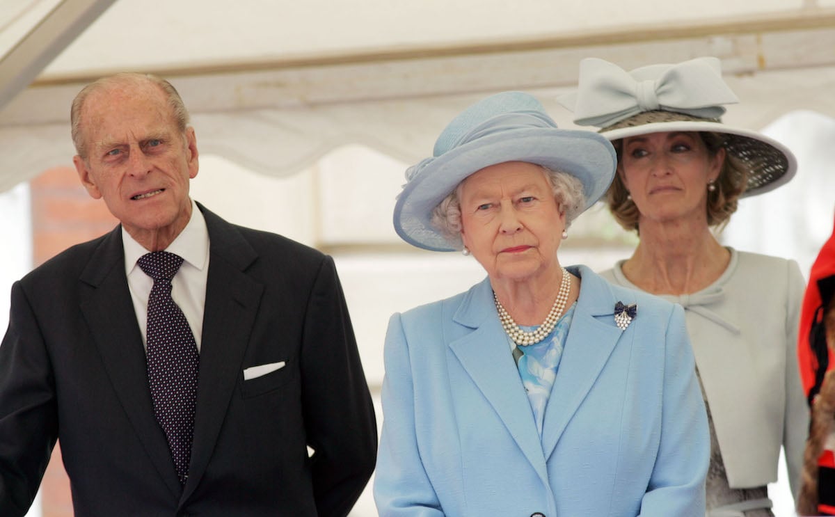 Prince Philip, who 'lights up' with Penny Knatchbull in old photos, according to a body language expert, walks with Queen Elizabeth II and Penny Knatchbull