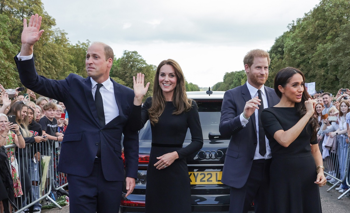 Prince William, Kate Middleton, Prince Harry and Meghan Markle wave to a crowd of well-wishers as they leave the Long Walk at Windsor Castle