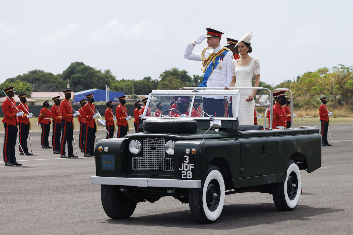 Prince William and Kate Middleton, who will likely 'stamp their personalities' on all future royal tours, according to a royal biographer, ride in a Land Rover during a royal tour of the Caribbean in 2022