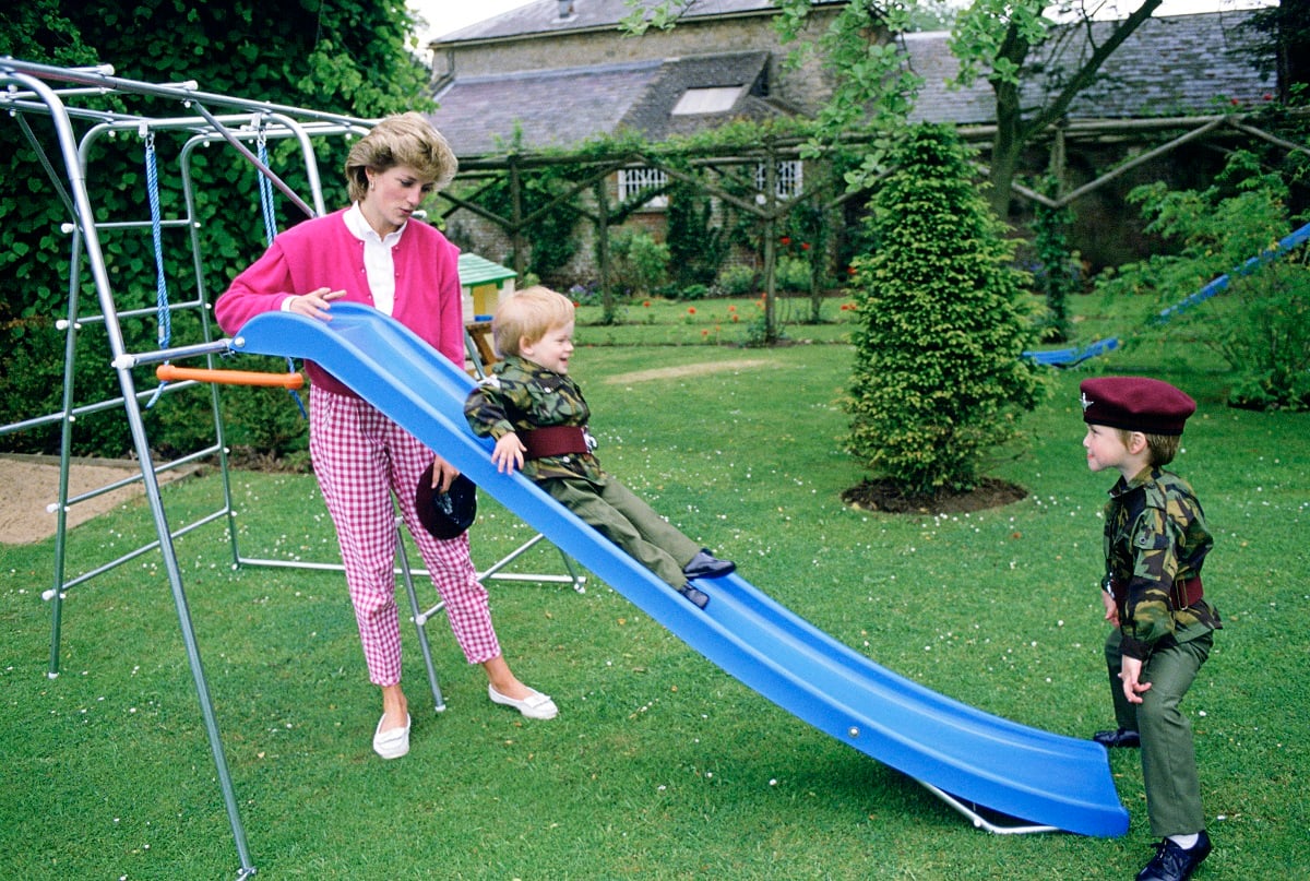 Princess Diana at Highgrove playing with Prince William and Prince Harry, who are dressed in miniature parachute regiment uniforms