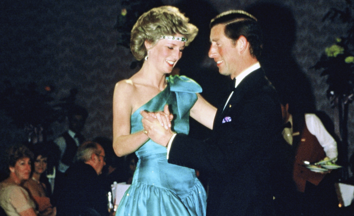 Prince Charles and Princess Diana wearing a green satin evening dress designed by David and Elizabeth Emanuel and an emerald necklace as a headband, dance together during a gala dinner dance at the Southern Cross Hotel on October 31, 1985 in Melbourne, Australia