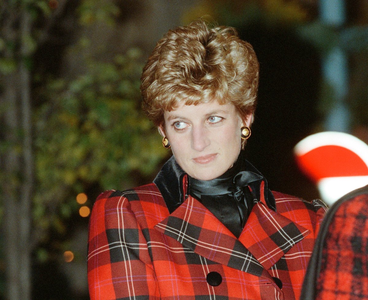 Princess Diana, who refused Queen Elizabeth's invitation to spend Christmas at Sandringham in 1995, according to Andrew Morton's 'Queen' book, looks on wearing a plaid coat in 1993