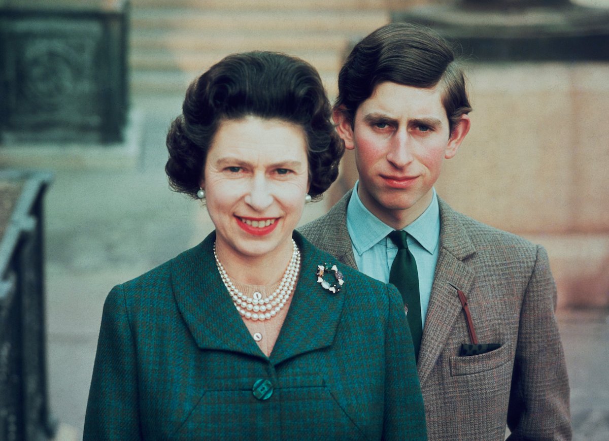 Queen Elizabeth II stands in front of King Charles III, who appeared in a childhood photo as Queen Elizabeth II shook his hand in what an author called a 'heartbreaking' moment, in 1969