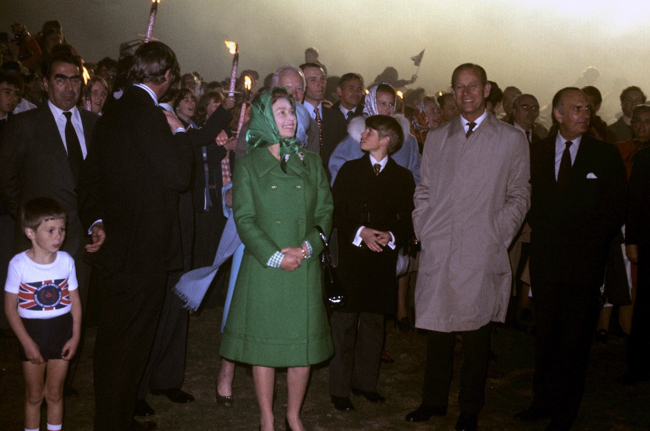 Queen Elizabeth II, the Duke of Edinburgh and their youngest son Prince Edward (center) at Snow Hill, Windsor Great Park, where the Queen lit a bonfire to mark the start of the Silver Jubilee celebrations.