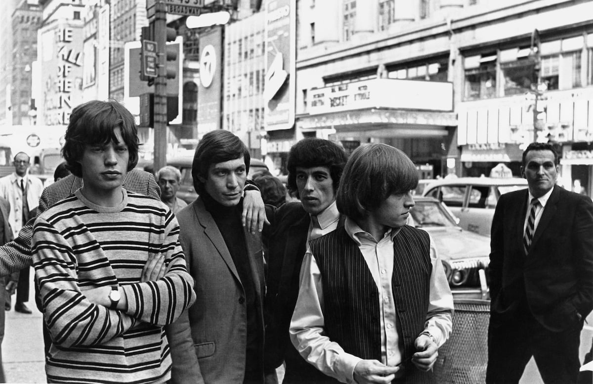 Mick Jagger, Charlie Watts, Bill Wyman, and Brian Jones of the Rolling Stones stand on an NYC street in 1964