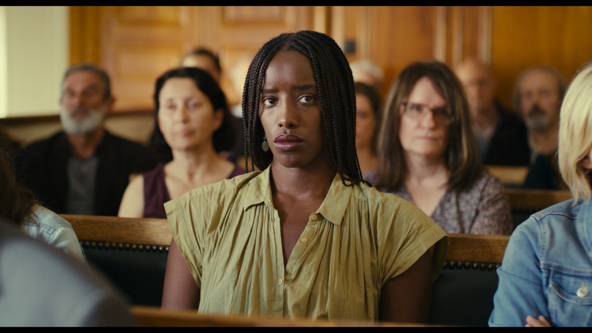 'Saint Omer' Kayije Kagame as Rama looking worried while sitting in the courtroom audience.