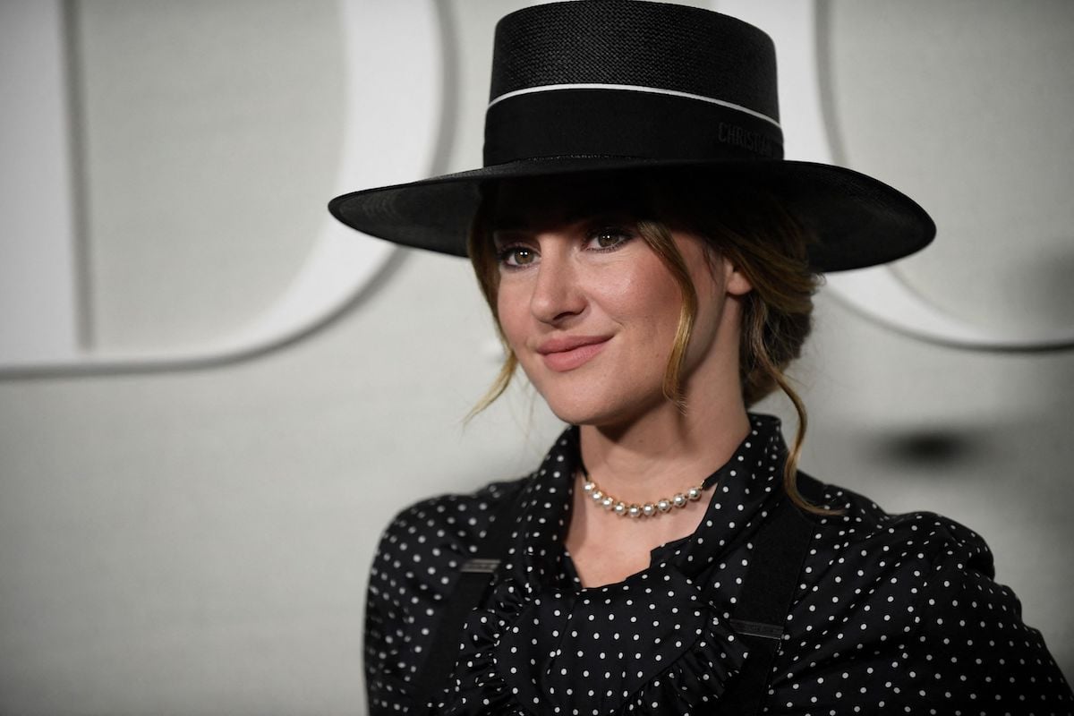 Shailene Woodley wearing a black top hat and suspenders