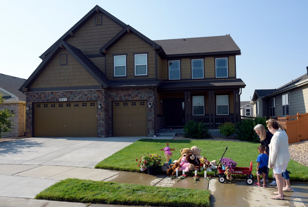 Neighbors place flowers in front of the Chris and Shanann Watts' home in Frederick, Colorado