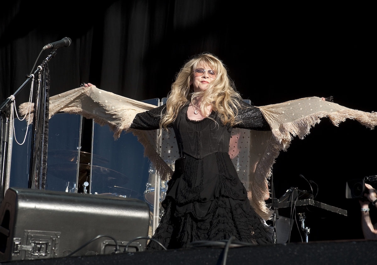 Stevie Nicks, who wants to publish the story of her life, spreads her arms and signature shawl on stage.