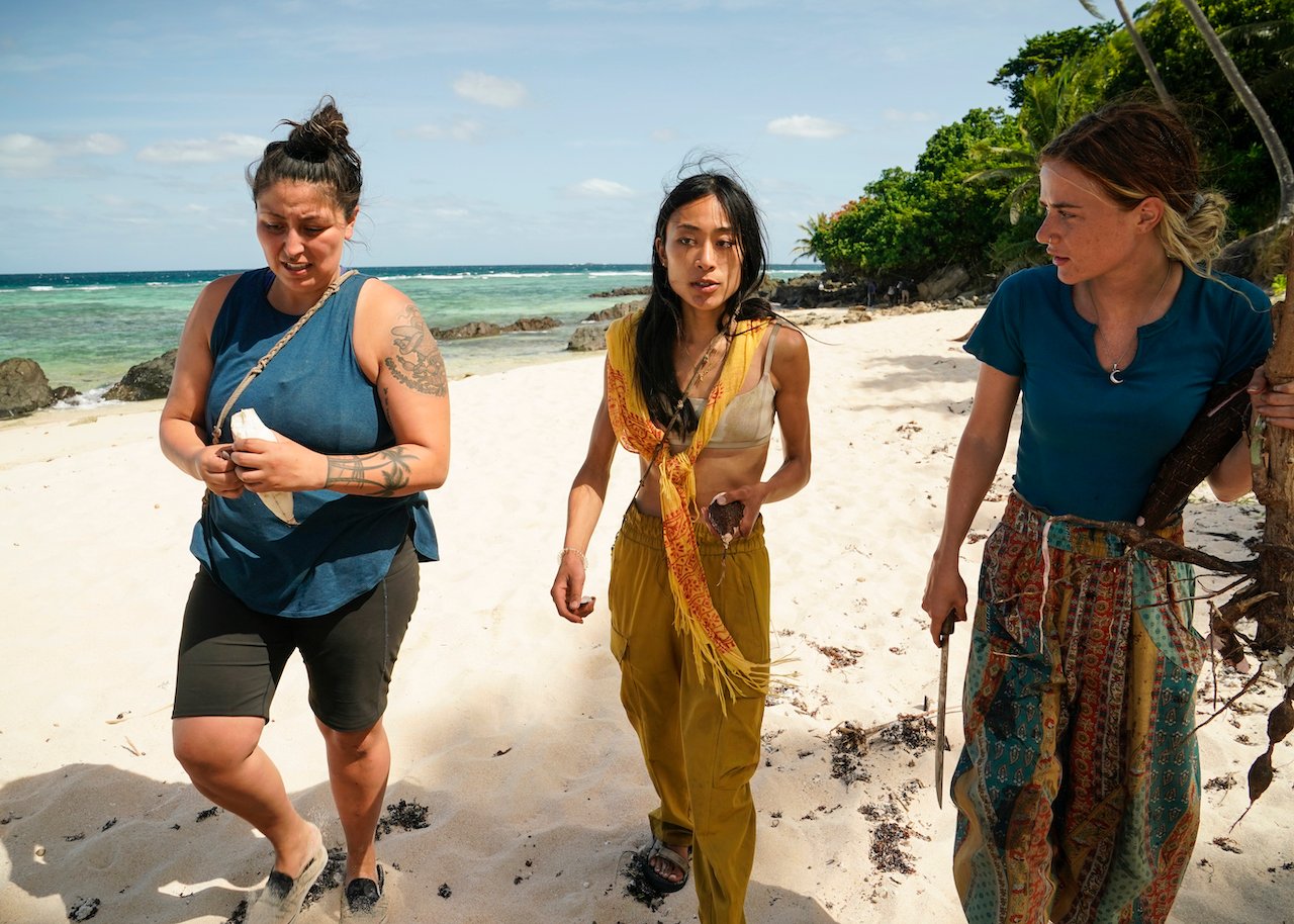 Karla Cruz Godoy, Jeanine Zheng and Cassidy Clark stand together on a beach on 'Survivor 43'.