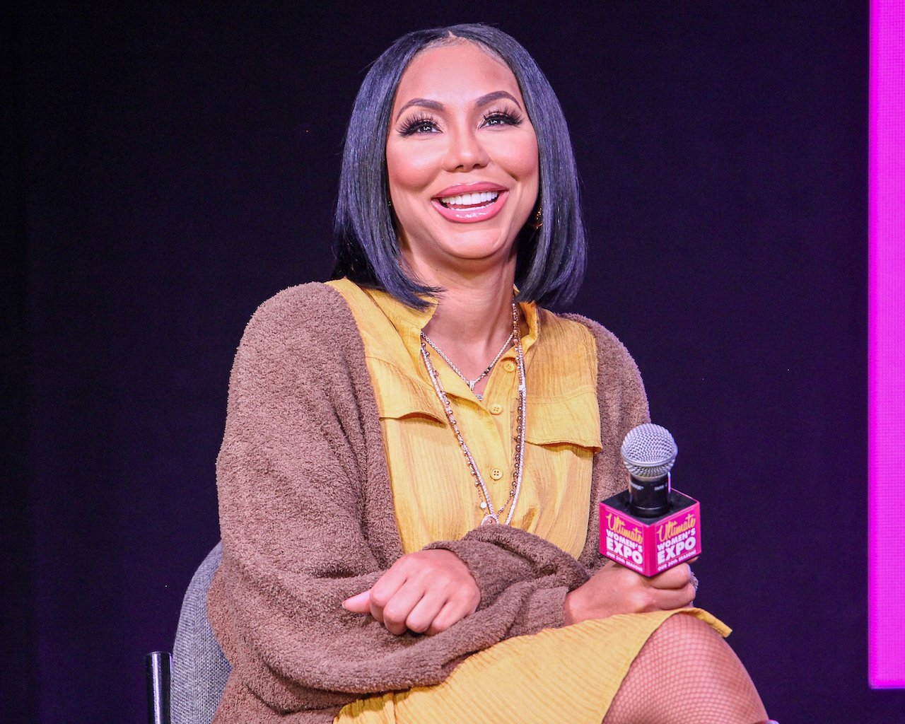 Tamar Braxton smiles during panel discussion; Braxton recently confirmed she's single
