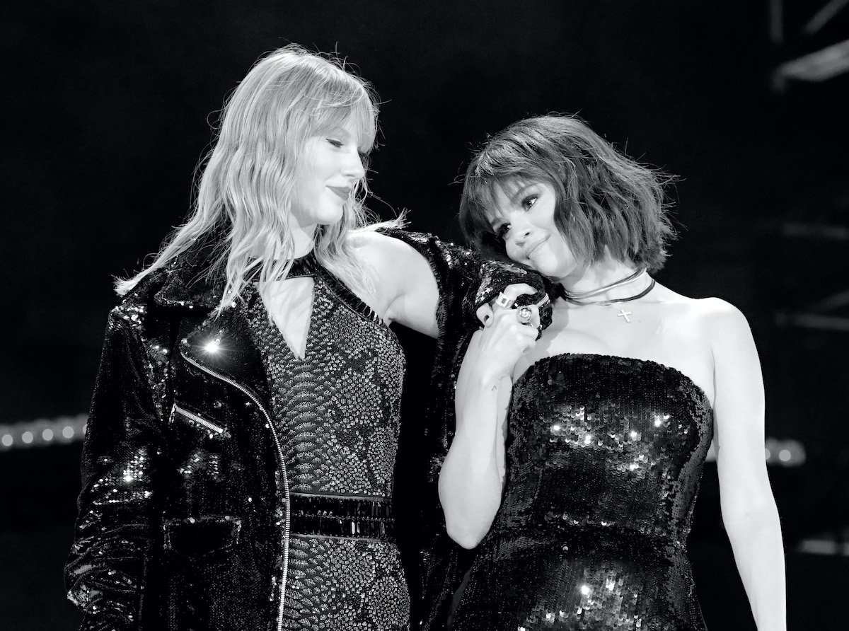 Selena Gomez leans on Taylor Swift in a display of friendship after they perform 'Hand to Myself'
