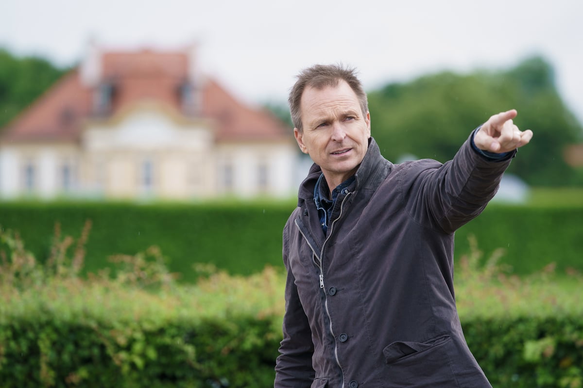 Amazing Race host Phil Keoghan points at contestants