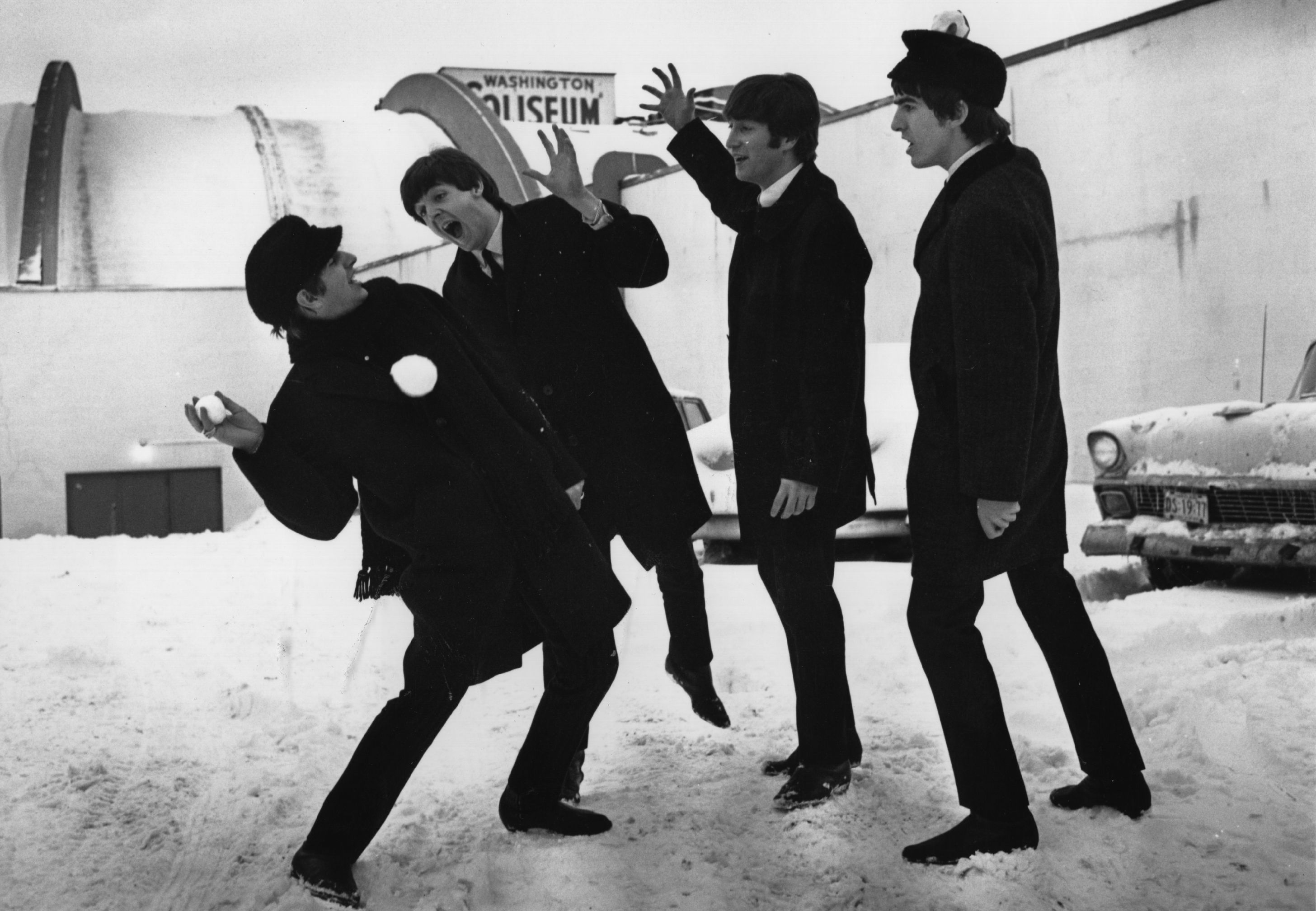 The Beatles have a snowball fight outside of the Coliseum in Washington, USA