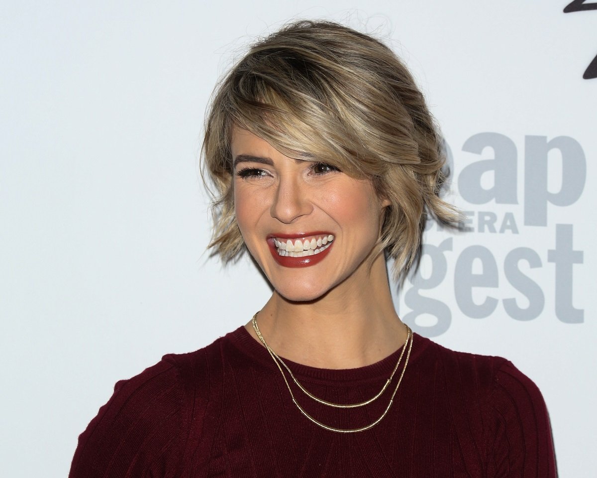 'The Bold and the Beautiful' star Linsey Godfrey wearing a burgundy dress and smiling for the camera.