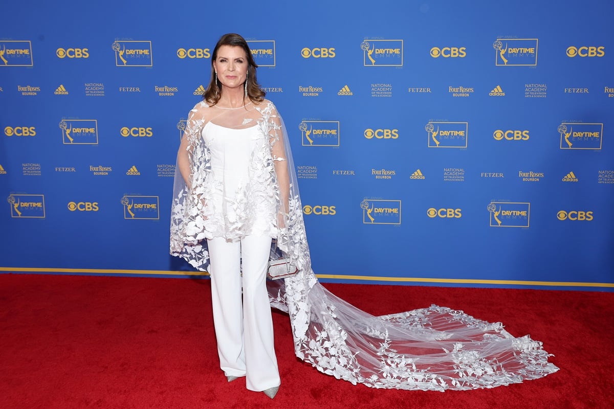 'The Bold and the Beautiful' star Kimberlin Brown wearing a white outfit and posing on the red carpet.